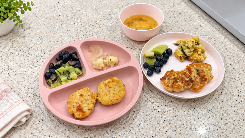 Chicken tofu veggie nuggets served with colorful vegetables on two kid-friendly plates